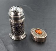 An imported silver pill box, of oval form with central oval amber cabochon, London import marks