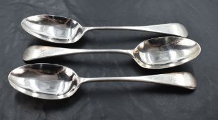 A group of three Edwardian silver Old English pattern table spoons, each with pip reverse and