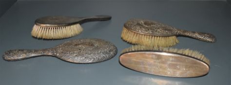 Four hallmarked silver backed dressing table items, (3 brushes and a hand mirror) 2 items AF