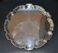 An Elizabeth II silver salver, of circular form with moulded 'Chippendale' design rim enclosing an