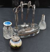 A 1930's silver and glass table top manicure set, the oval clear glass platform with recessed