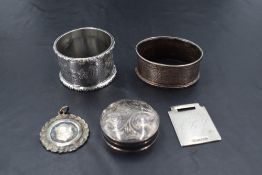 A small group of mixed silver, to include two napkin rings, circular pill box and two medallions,