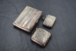 A hallmarked silver cigarette case having engine turned stripe decoration, (af) and two hallmarked
