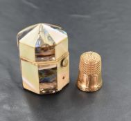 A yellow metal thimble, of traditional design, engraved with initials and marked '9' 5.3grams,