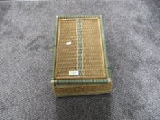 A small fibre woven sewing basket with a selection of haberdashery items