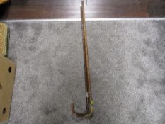Two Victorian bamboo effect walking canes one with horn handle and silver tip, other with bent