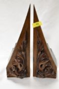A heavy pair of 1920s/ 30s book ends with foliate carved frontages and slate to back.