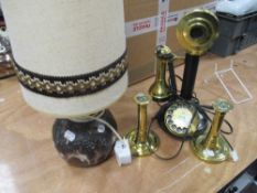 A mid century studio pottery lamp having lava like design, a pair of brass candle sticks and a