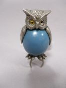 A mid century novelty retracting tape measure in the form of an owl.