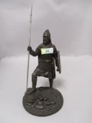 A cast metal Viking warrior figurine, with shield and spear.