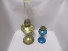 Two Victorian oil burning lamps including brass bodied and a blue glass light