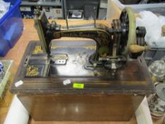A Victorian Faudels London hand cranked sewing machine with fitted case