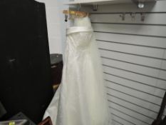 A modern Maggie Sottero wedding dress in box with a pair of matching shoes