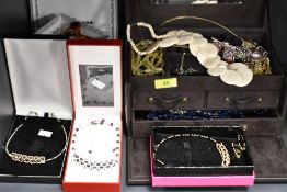 A selection of modern costume jewellery in case with necklaces in boxes