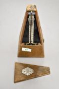 An antique Paquet musicians metronome