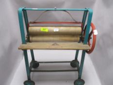 A vintage Tri-Ang child's painted metal framed mangle, some old worm damage to rollers