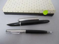 A Parker fountain pen and retracting pencil set in box, both having black barrels with brushed steel