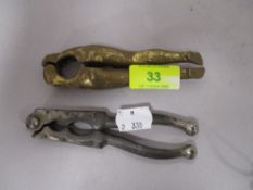 Two antique nut crackers, one in the form of a pair of nude female legs.