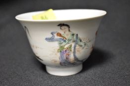 A 19th century Japanese porcelain tea bowl decorated with geisha and bearing seal mark to footed