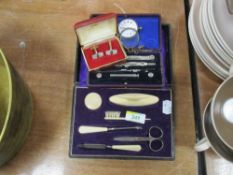 A .935 grade Swiss white metal fob watch (AF) sold along with a cased manicure set and cased drawing