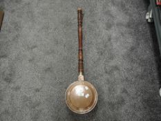 A small sized copper and brass bed warming pan with turned handle
