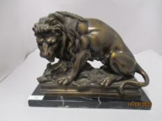 A Victorian cast bronze or bronzed metal study of a lion with boar, on marble base.