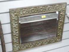A Victorian Arts and Crafts era brass framed mirror
