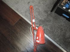 A vintage machinist or engineers desk lamp in red