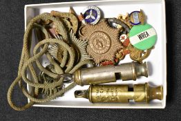 Two whistles one marked with military foot 1943 and other Metropolitain, also Cheshire cap badges