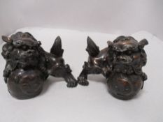 Two composite wood finish dogs of Fo.