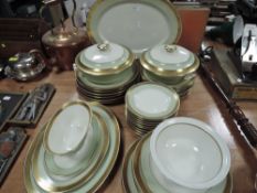 A Royal Copenhagen part dinner service in a pale green and gilt pattern no988, 9577