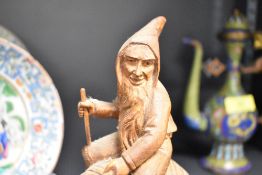 An early 20th century carved wood fantasy figure of a Gnome riding a snail possibly from Hans