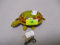 A mid century clock work tin tortoise, in working order, with key.