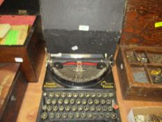 An early 20th century Smith Premier Chum Portable type writer with case