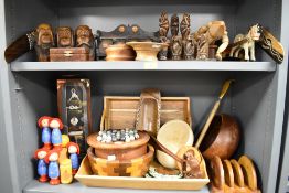 A large selection of 20th century treen wood items over two shelves including 'see no evil' monkeys,