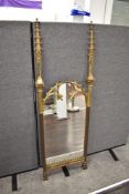 A mid Victorian Pugin style mirror , having decorative finials to sides with mirrored inserts in a