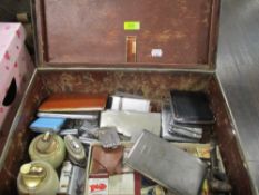 A vintage card leather effect case containing a selection of smoking paraphernalia, cigarette