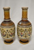 A pair of antique Mettlach German vases having brown ground with floral details, one vase AF.