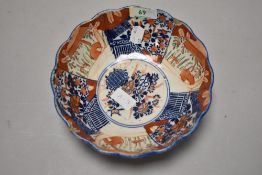 An early 20th century Japanese porcelain bowl with scalloped design in Imari pattern
