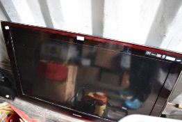 A Samsung TV, and stand (stand not currently attached)
