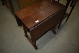 An Arts and Crafts oak drop flap occasional table (foot off)