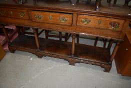 A Period oak dresser base having triple frieze drawers over open lower section with some nice inlaid