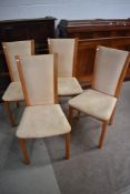 A set of four modern chairs having suedette upholstery