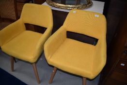 A pair of mustard yellow modern waiting chairs, in a vintage style