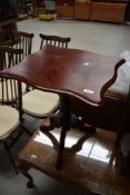 A reproduction mahogany effect low pedestal occasional table