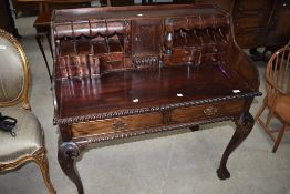 A reproduction period style desk having gadrooned design, with ball and claw feet