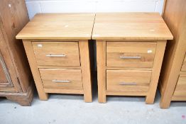 A pair of modern golden oak bedside cabinets