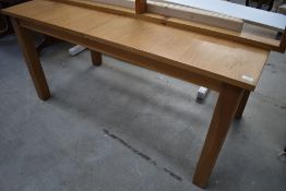 A golden oak effect kitchen table