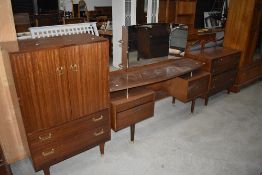 A mid century G Plan dressing table with mirror back, and two matching chest of drawers