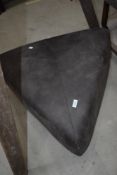 A modern pouffe of triangular form
